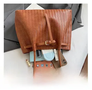 Top view of brown woven tote bag interior showing large capacity for tablet and cosmetics