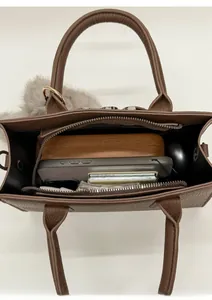 Internal view of dark brown litchi pattern leather bag showing spacious capacity