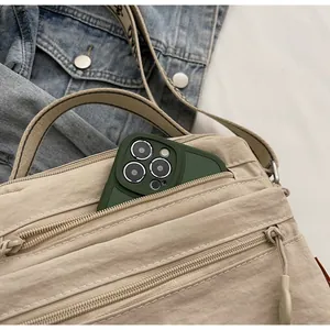 Detail view of beige nylon crossbody bag interior with ample space for a large smartphone