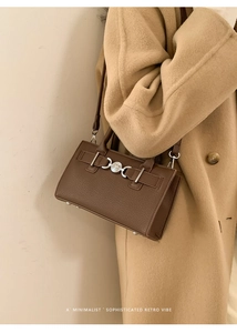 Retro dark brown pebbled leather crossbody bag paired with a stylish camel wool coat