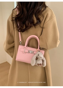 Pink crossbody square bag detail with silver buckle and cute gray rabbit plush charm