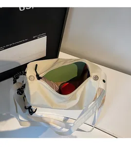 Interior view showing large capacity and zipper pocket of the checkered canvas crossbody bag