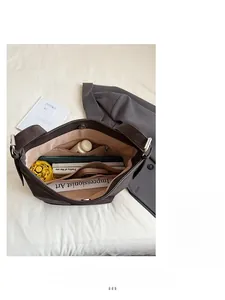 Interior view of large capacity dark brown tote bag showing multiple pockets and storage space