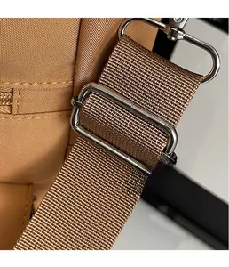 Detail of durable khaki canvas strap with polished silver metal swivel hook and slider