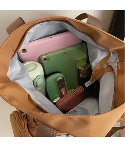 Top view of large canvas tote bag showing spacious interior with tablet and water bottle