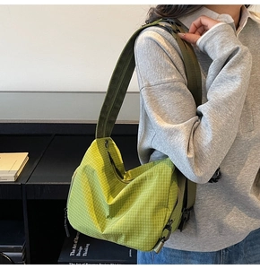 Detail of neon green checkered nylon crossbody bag with adjustable dark green strap