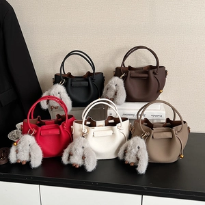 Pleated bucket bags in five colors with plush rabbit charms and top handles