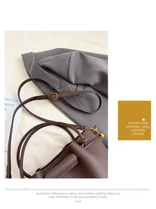 Detail shot of deep brown lychee grain leather handbag with gold adjustable buckle