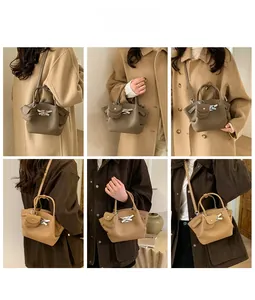 Fashionable pleated bucket bag styled with a matching mini coin pouch and silver buckle