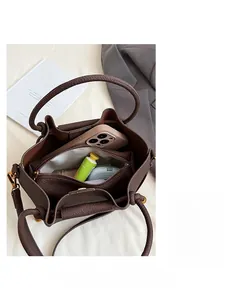 Detail of spacious brown pebbled leather bag interior with zipper pocket and lining