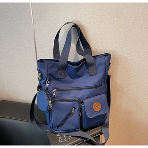 Navy nylon tote bag with multiple pockets, thick handles and a detachable coin purse