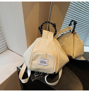 Detail of off-white checkered mini backpack with top rope handle and brand patch