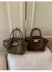 Close-up of retro bucket bags in brown and coffee leather with lychee grain texture