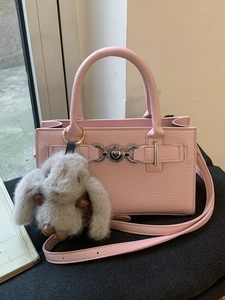 Pink lychee grain leather crossbody handbag with heart buckle and rabbit plush charm