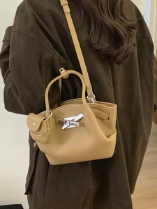 Khaki pebbled leather bucket bag with silver metal buckle and mini pouch accessory