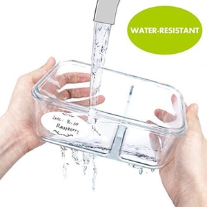 Waterproof food labels for storage jars on a clear glass container under running water
