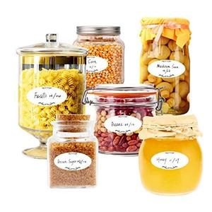Waterproof white oval kitchen storage labels with black borders on glass food jars