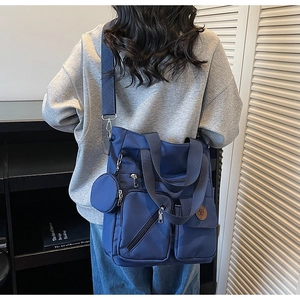 Navy blue large capacity tote bag with multi-pocket design and small round purse