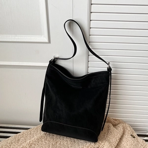 Retro black faux suede bucket bag with adjustable shoulder strap and silver hardware