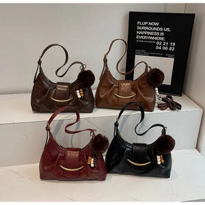 Detail view of ruched dumpling bags in four colors with crescent metal hardware