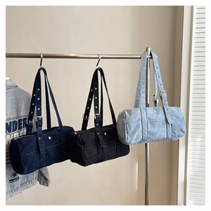 Detailed trio of vintage denim barrel bags in blue and black with silver buckles