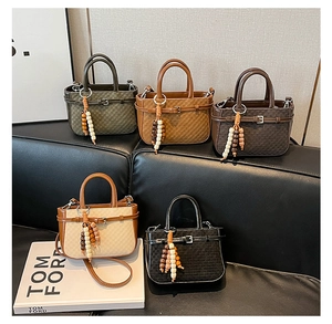 Detailed display of vintage woven mini handbags in five colors with wooden bead charms