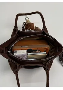 Top view of brown suede bucket bag interior showing spacious storage for daily items