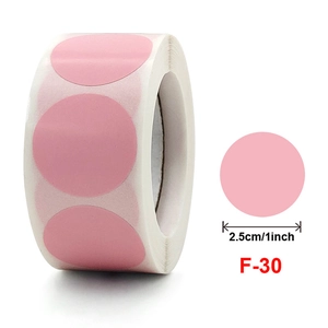 Détail d'autocollants ronds roses en rouleau avec indication du diamètre de 2,5 cm