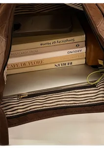 Internal view of brown quilted tote bag showing large capacity for laptop and books