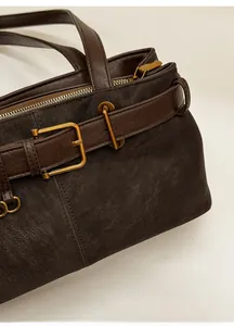 Detailed macro view of vintage brown leather bag with retro bronze hardware buckle