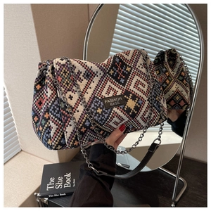 Detail of bohemian geometric woven tote bag with chain strap and fashion label