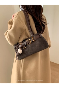 Detail of dark brown retro baguette bag with gold buckle and ice cream charm on model
