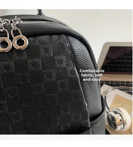 Close-up of black checkered embossed leather backpack with dual silver zippers