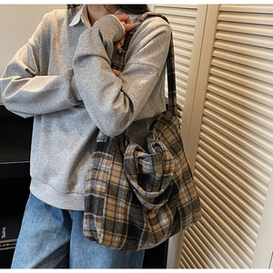 Detail of vintage plaid tote bag featuring yellow and grey checkered pattern