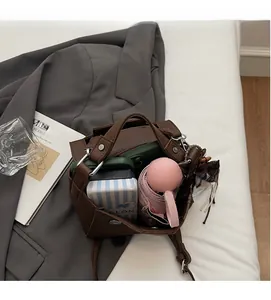 Top view of deep brown leather square bag showing spacious interior with daily essentials