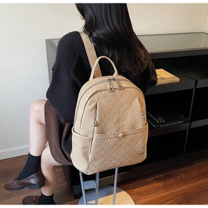 Modern beige backpack featuring geometric lattice pattern and spacious side pockets