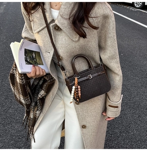 Detail of dark brown retro square crossbody bag with decorative beads and slim strap