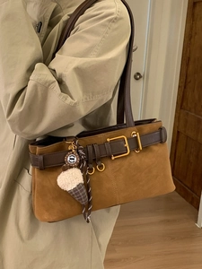 Vintage brown suede baguette shoulder bag with leather strap and decorative charm
