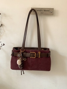 Vintage burgundy baguette shoulder bag with leather belt detail and plush charm