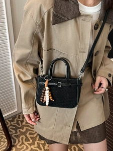 Black woven texture crossbody bag with top handles and a colorful beaded charm