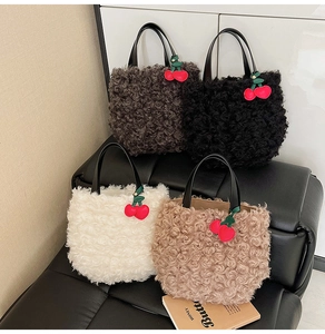 Detailed close-up of fluffy faux fur bucket bags in four colors with cherry charms