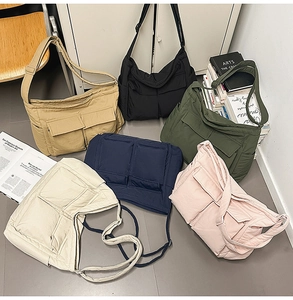 Flat lay of lightweight nylon messenger bags showing front flap pockets and straps