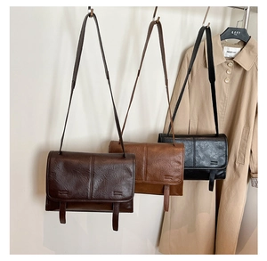 Close-up of vintage textured shoulder bags in black and brown colors with pleated leather