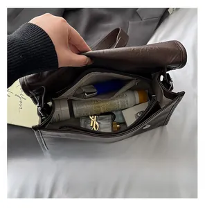 Internal compartments of a dark brown vintage tote bag showing large storage capacity