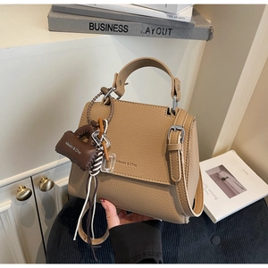 Detailed view of the premium brown lychee pattern leather and Maven & Chic logo