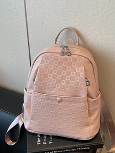 Pink pebbled leather women's backpack featuring Gancini pattern and dual-zipper closure