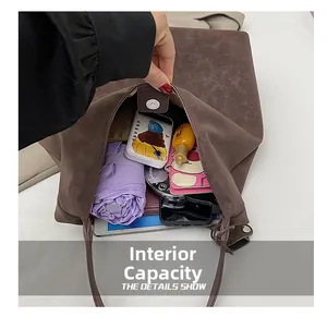 Detail view of large brown tote bag showing internal capacity with daily essentials
