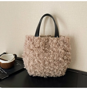 Macro shot of fluffy beige plush bucket bag texture with contrast black leather handles