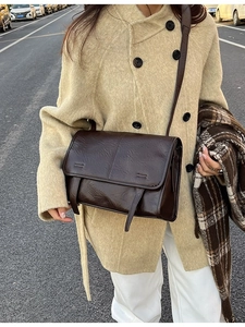 Vintage brown leather tote bag with flap and decorative straps for autumn fashion