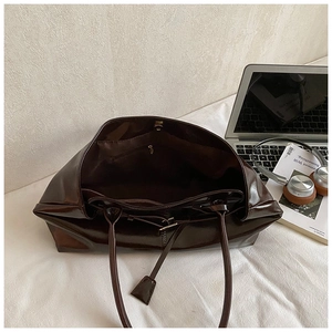 Interior view of the dark brown oil wax leather tote bag showing large capacity and zipper pocket